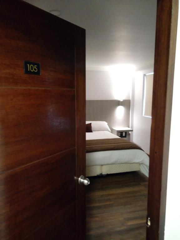 Postel nebo postele na pokoji v ubytování Hotel Elisa Cole