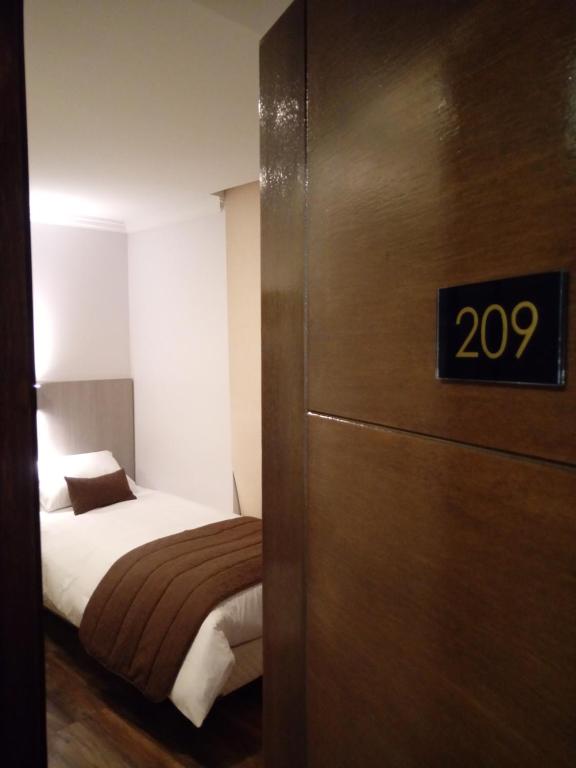 Postel nebo postele na pokoji v ubytování Hotel Elisa Cole
