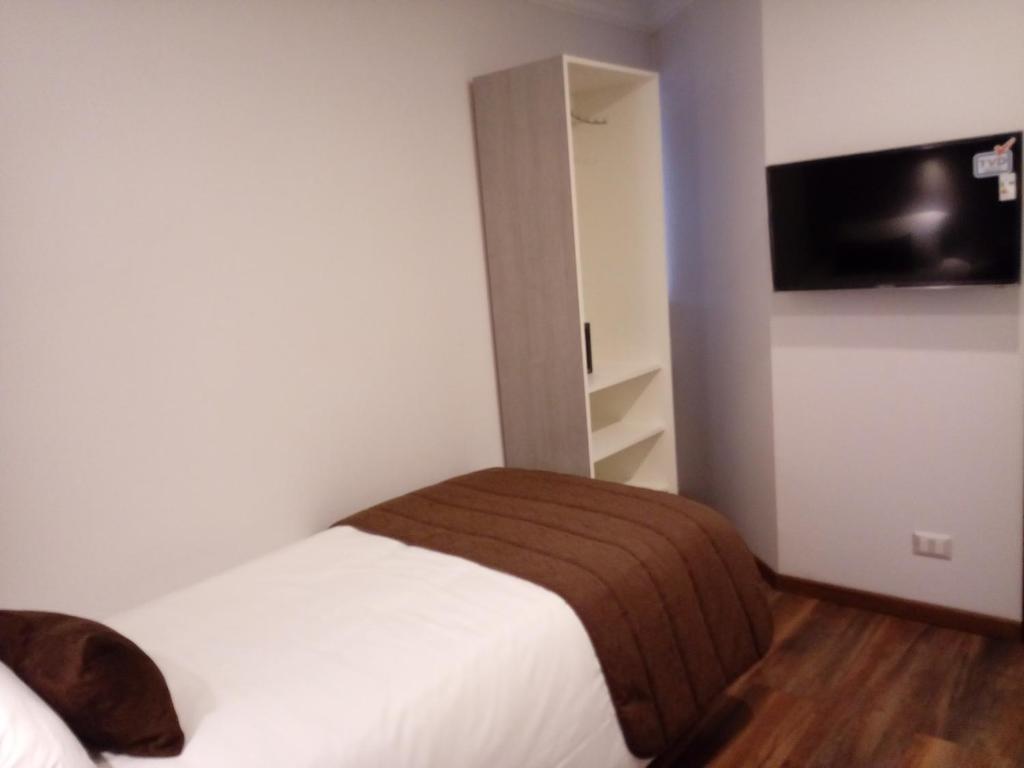 Postel nebo postele na pokoji v ubytování Hotel Elisa Cole