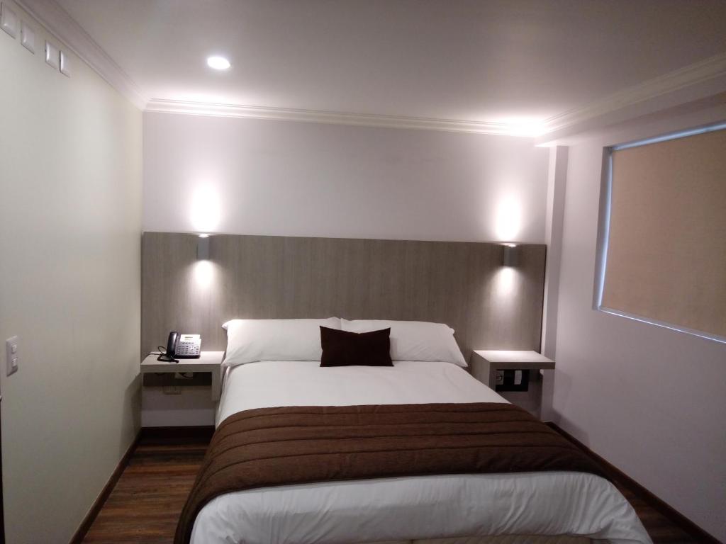 Postel nebo postele na pokoji v ubytování Hotel Elisa Cole