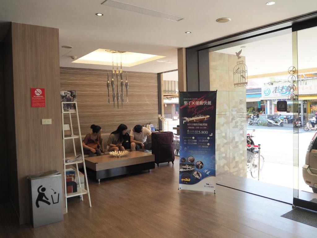 a group of people sitting at a table in a store at The Riverside Hotel Hengchun in Hengchun South Gate