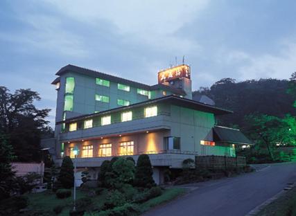 a building with a lit up sign on top of it at Musashibou in Hiraizumi