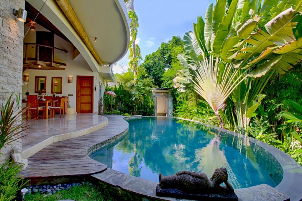 a swimming pool in the backyard of a house at Mayana Villas in Canggu