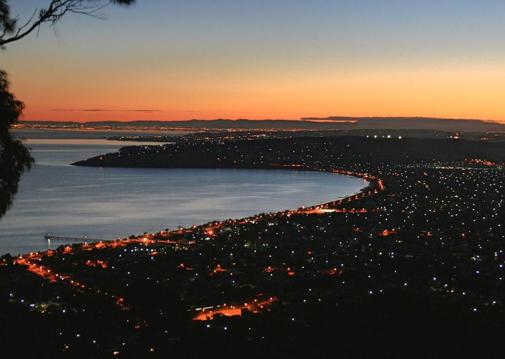a view of a city at night with the water at Dream Views at Arthurs Seat B & B in Arthurs Seat