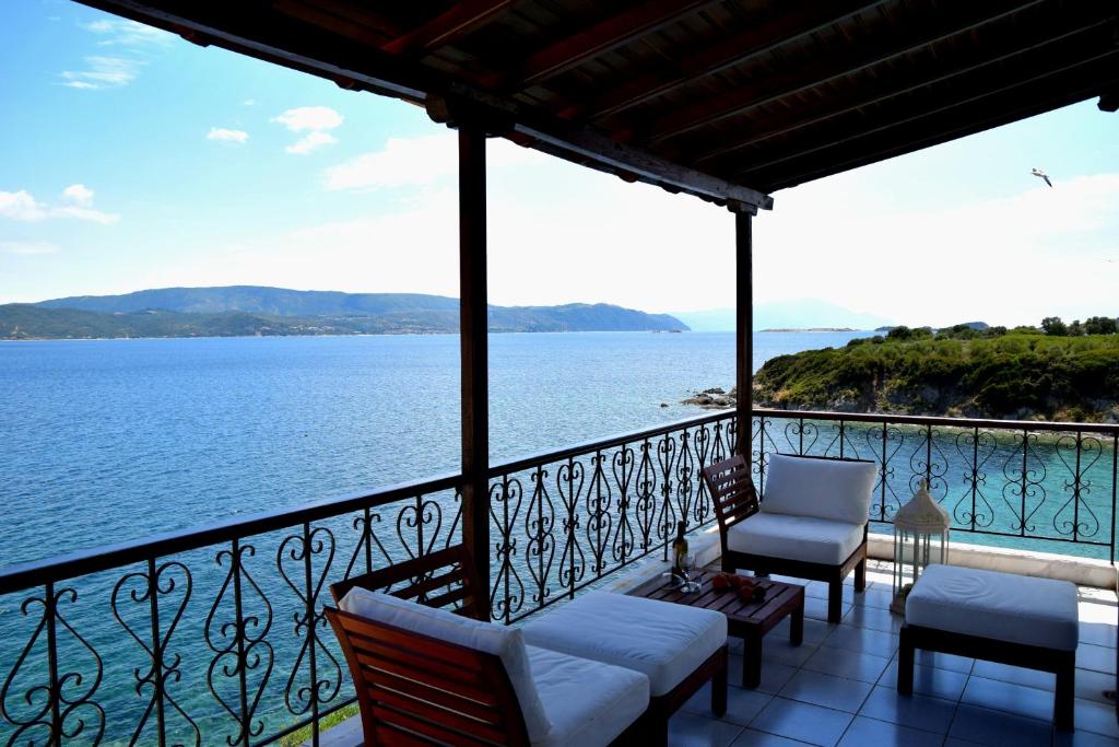 a balcony with chairs and a view of the water at Villa Evi in Ammouliani