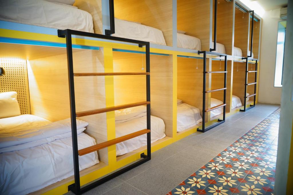 a group of bunk beds in a dorm room at Borough Capsule Hostel Bali in Legian