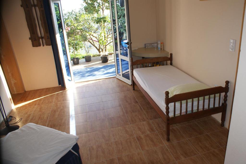 a room with two beds and an open door at Apartments Olga in Ulcinj
