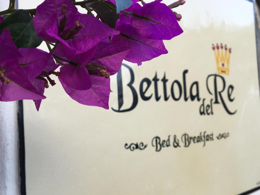 a sign for a restaurant with purple flowers on it at Bettola Del Re Capri Home boutique b&b in Anacapri