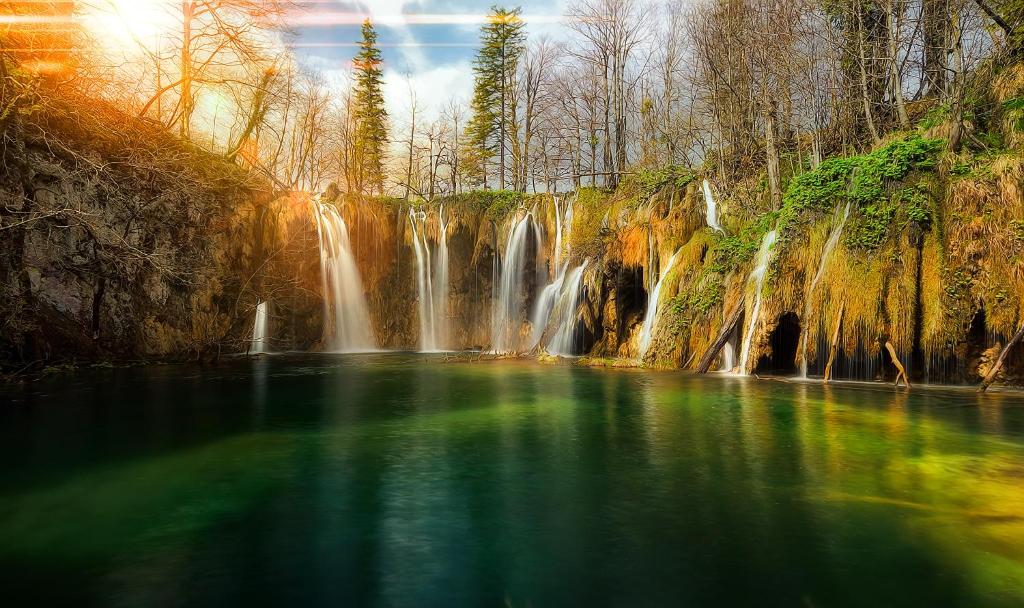 a waterfall in the middle of a pool of water at Apartments Sabljak in Rakovica