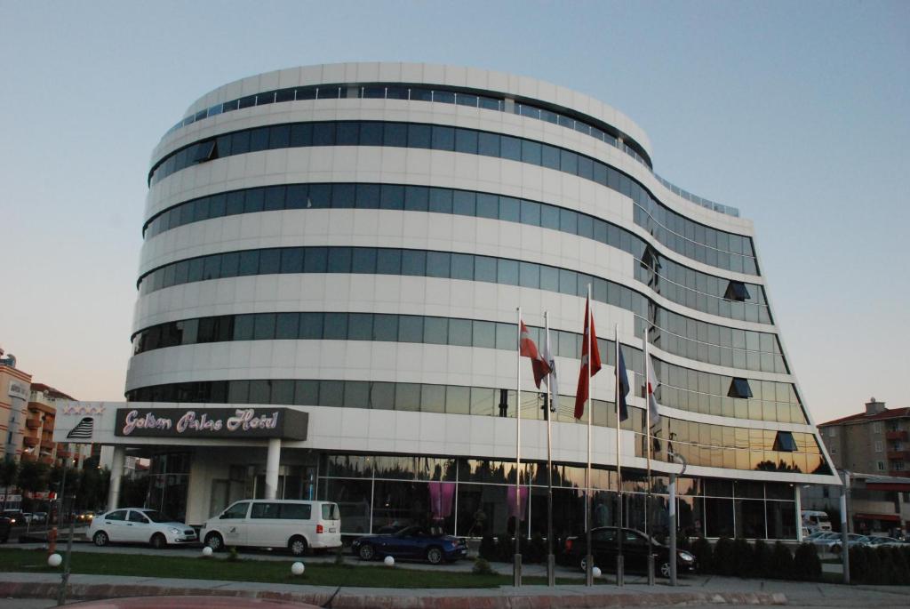 a large building with flags in front of it at Golden Palas Hotel in Cerkezkoy