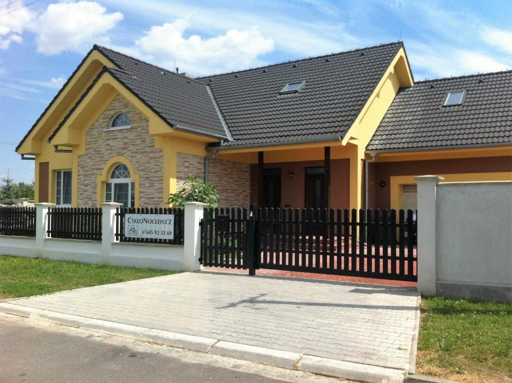a house with a black fence in front of it at Cyklonocleh in Veselí nad Moravou