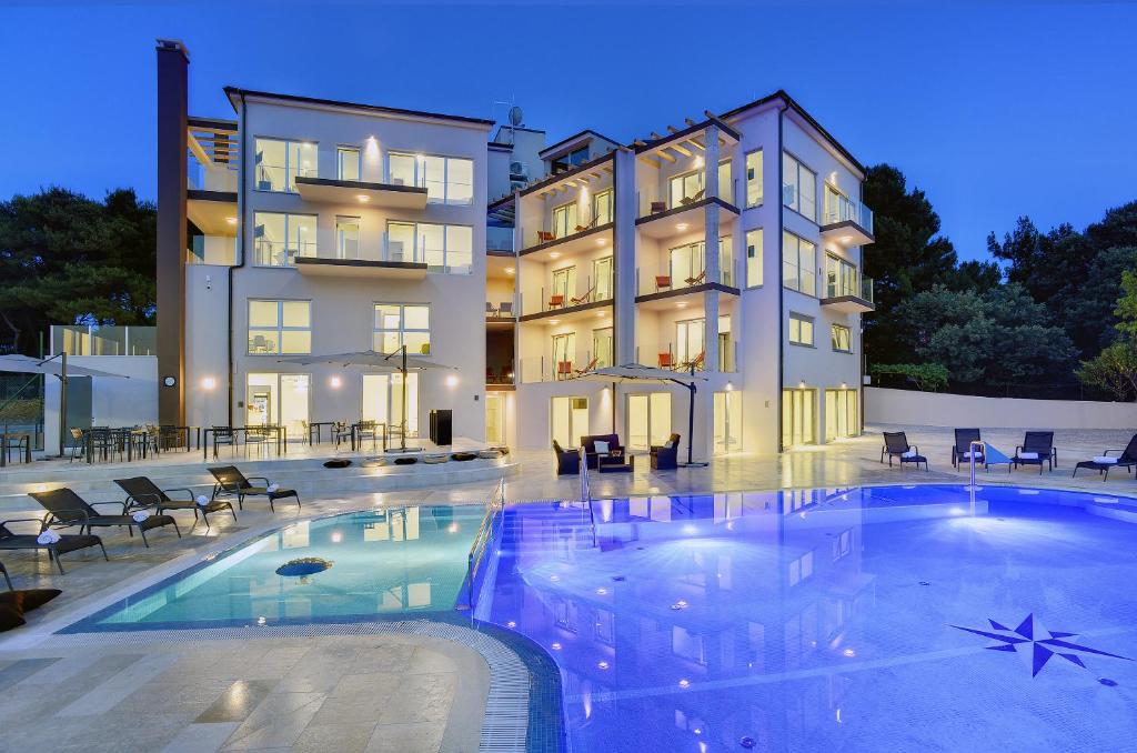 a large swimming pool in front of a building at Premantura Resort - Hotel & Restaurant in Premantura