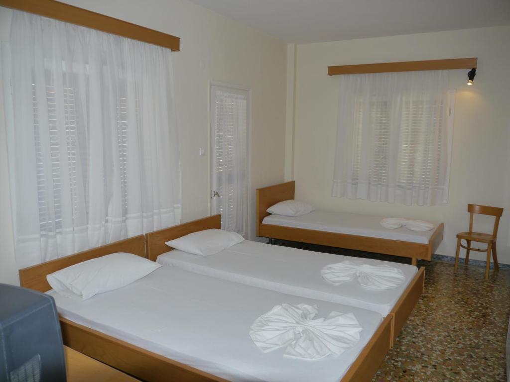 Postel nebo postele na pokoji v ubytování Hotel Markos
