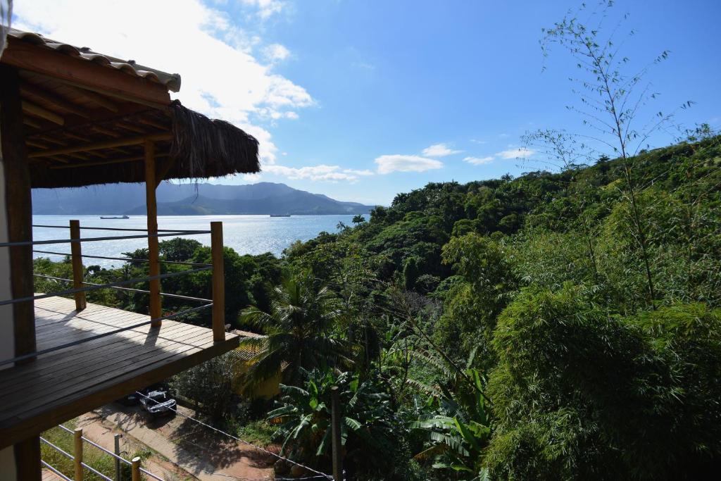 a balcony of a house with a view of the ocean at Villa Girassol in Ilhabela