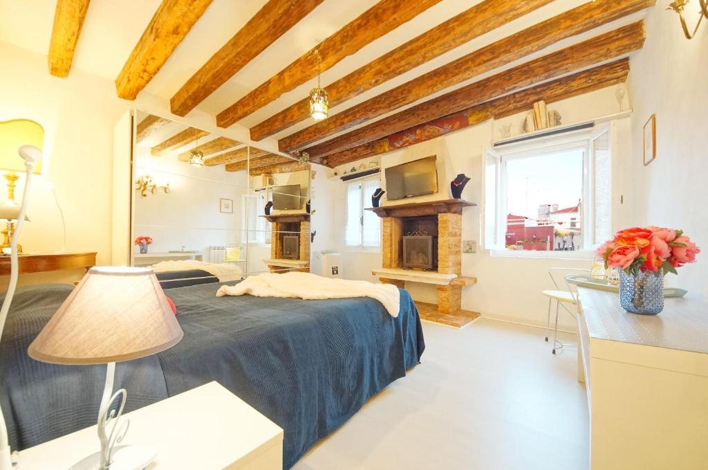 a bedroom with a bed and a table with a lamp at DolceVita Apartments N 185 in Venice