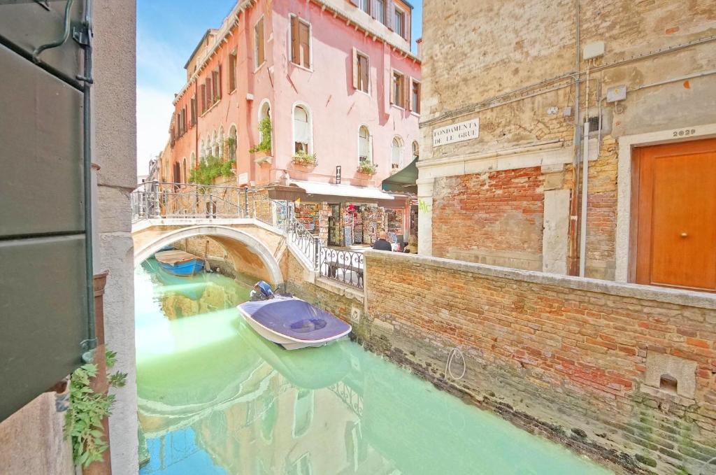 a view of a canal with a boat in the water at DolceVita Apartments N 181 in Venice