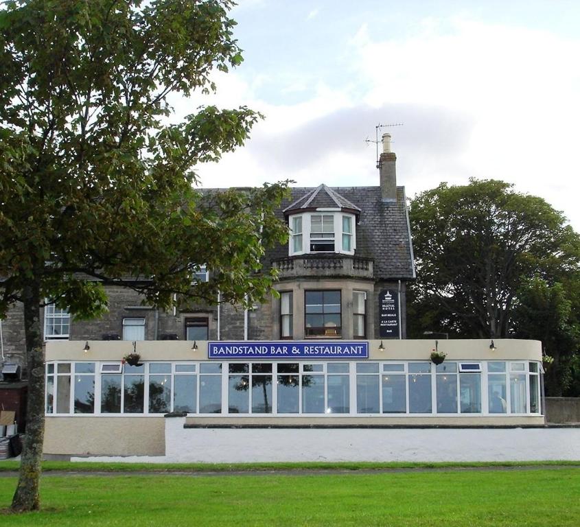 a large building with a clock on the front of it at The Bandstand in Nairn
