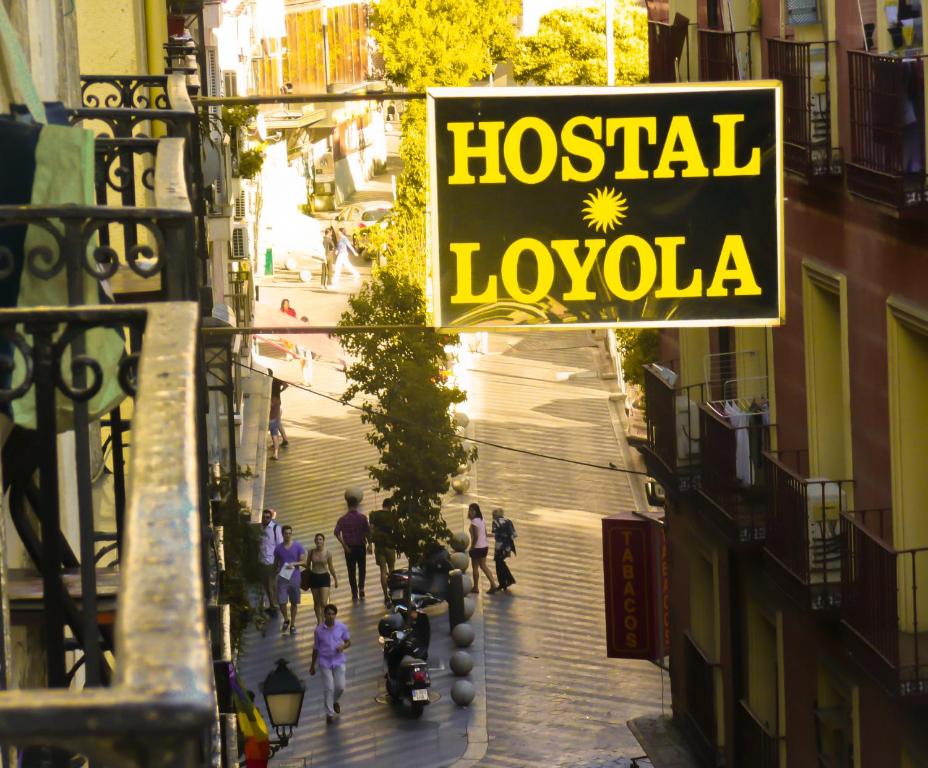 a sign that reads hospital laochowa on a city street at Hostal Loyola in Madrid
