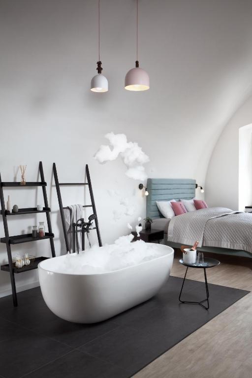 a living room with a large white tub in the middle at Long Story Short Hostel &amp; Café in Olomouc