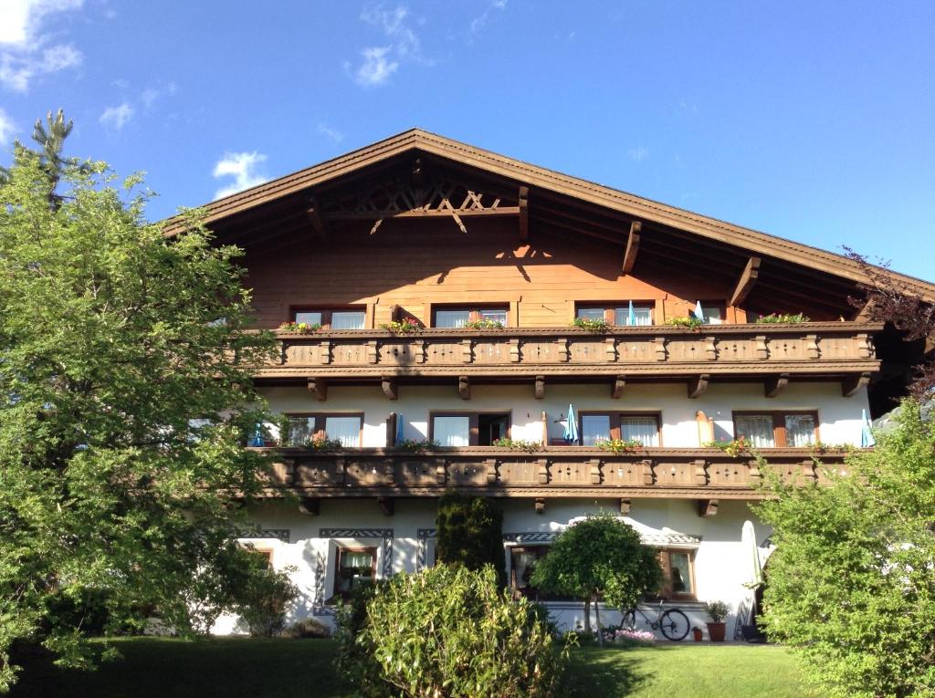 a building with a balcony on top of it at Hotel Garni Almhof in Seefeld in Tirol