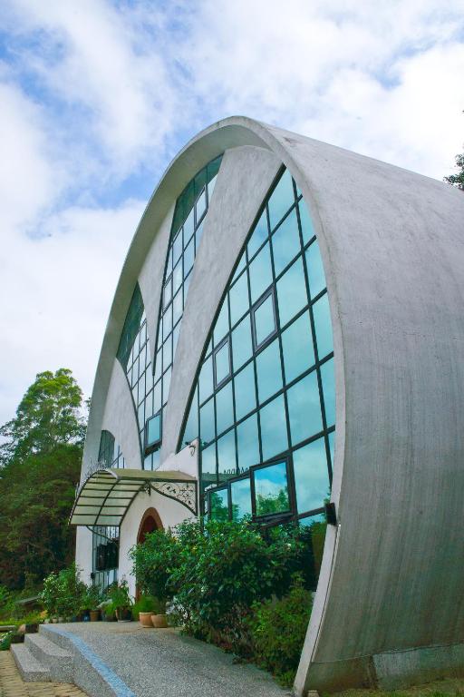 a building with a large window on the side of it at Maison-Philo Homestay B &amp; B in Sanyi