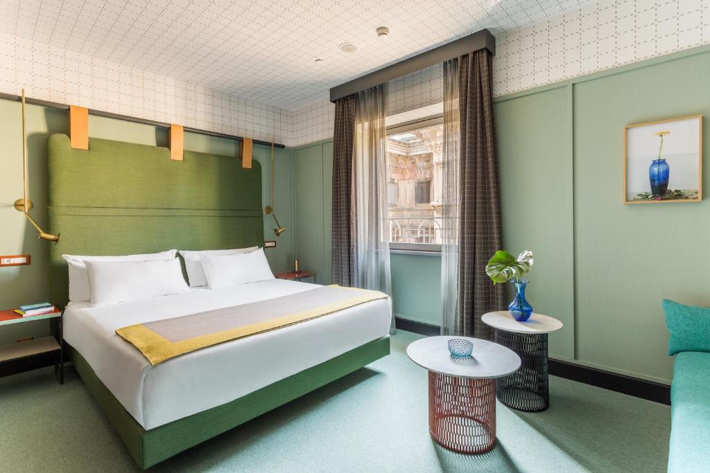 a hotel room with a bed and a window at Room Mate Giulia in Milan