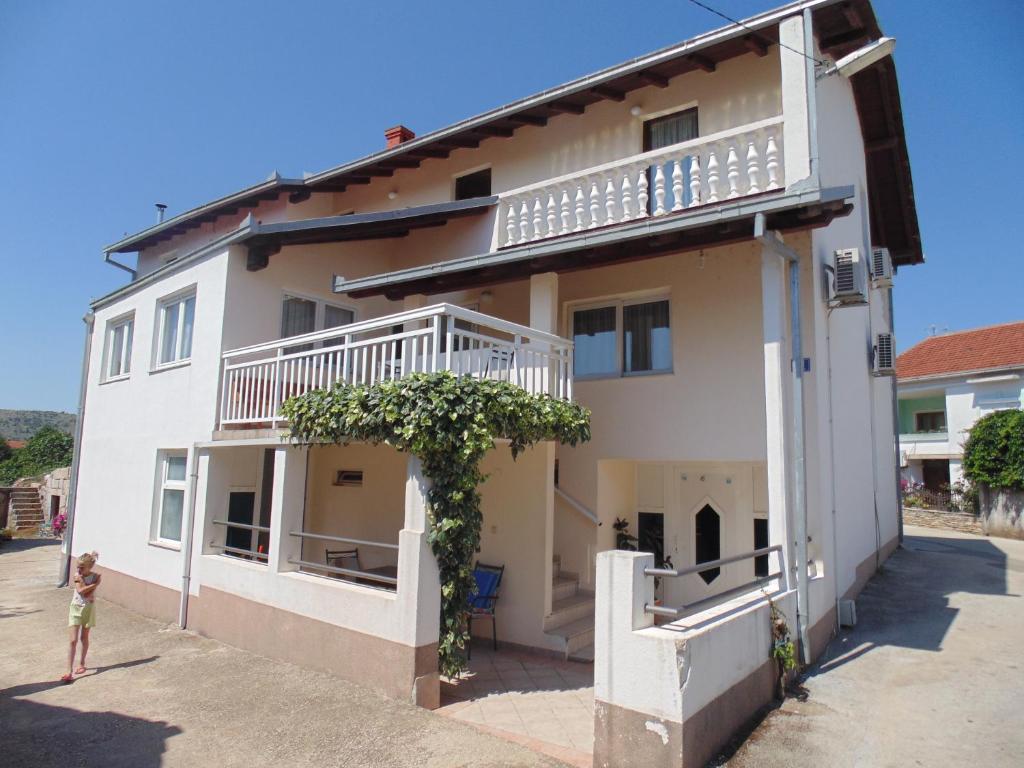 a woman standing in front of a building at Pansion Luka in Međugorje