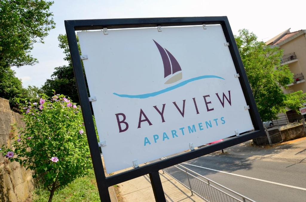 a sign for a bayview aquatic institution at Bay View Apartments in Kotor