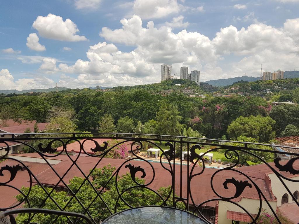 a balcony with a view of a park through a gate at Sophia Suites Residence Hotel in Cebu City