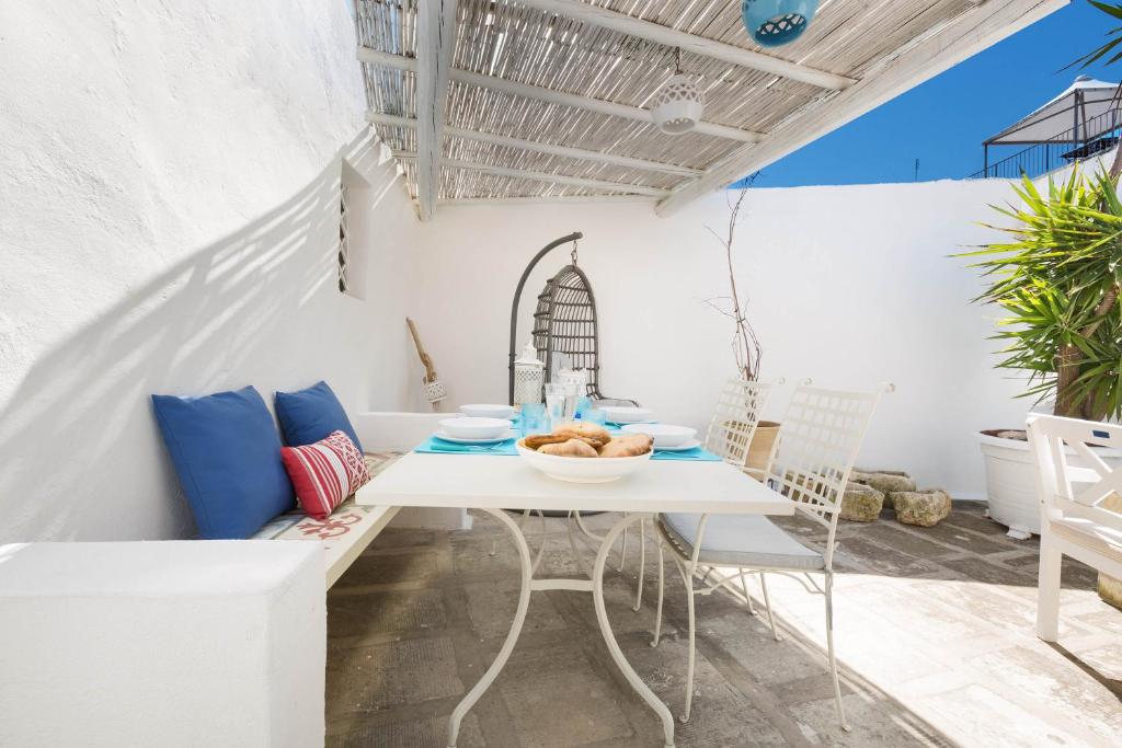 a white table and chairs on a patio at Appartamento Al Bastione by BarbarHouse in Otranto