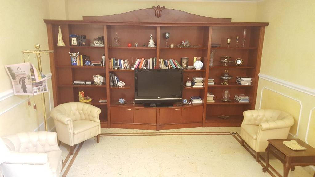 a living room with a entertainment center with a television at Hotel Corallo in Francavilla al Mare