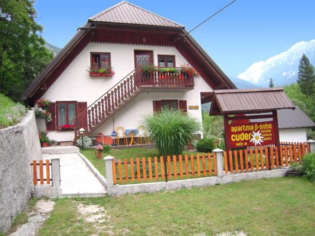 a small house with a fence in front of it at Apartmaji in Sobe Cuder in Soča