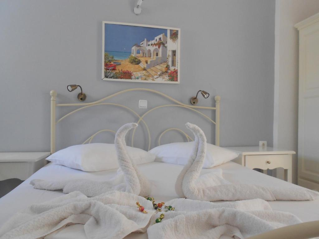 Dos toallas de cisne sobre una cama en Nicolas Antiparos, en Antíparos