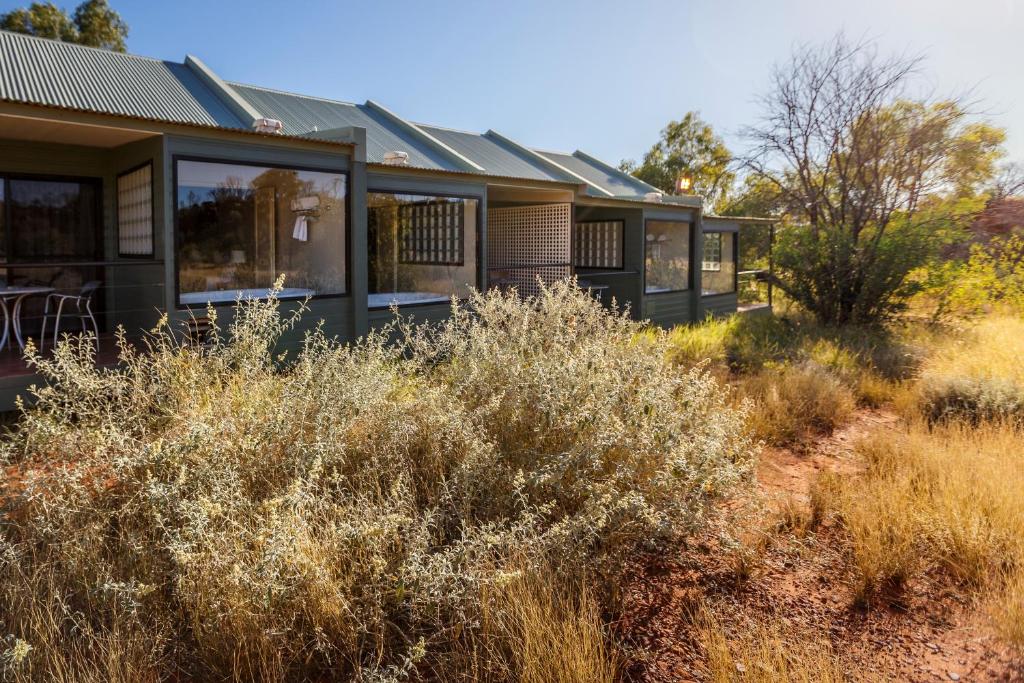 a row of modular homes in a field of tall grass at Discovery Resorts - Kings Canyon in Kings Canyon
