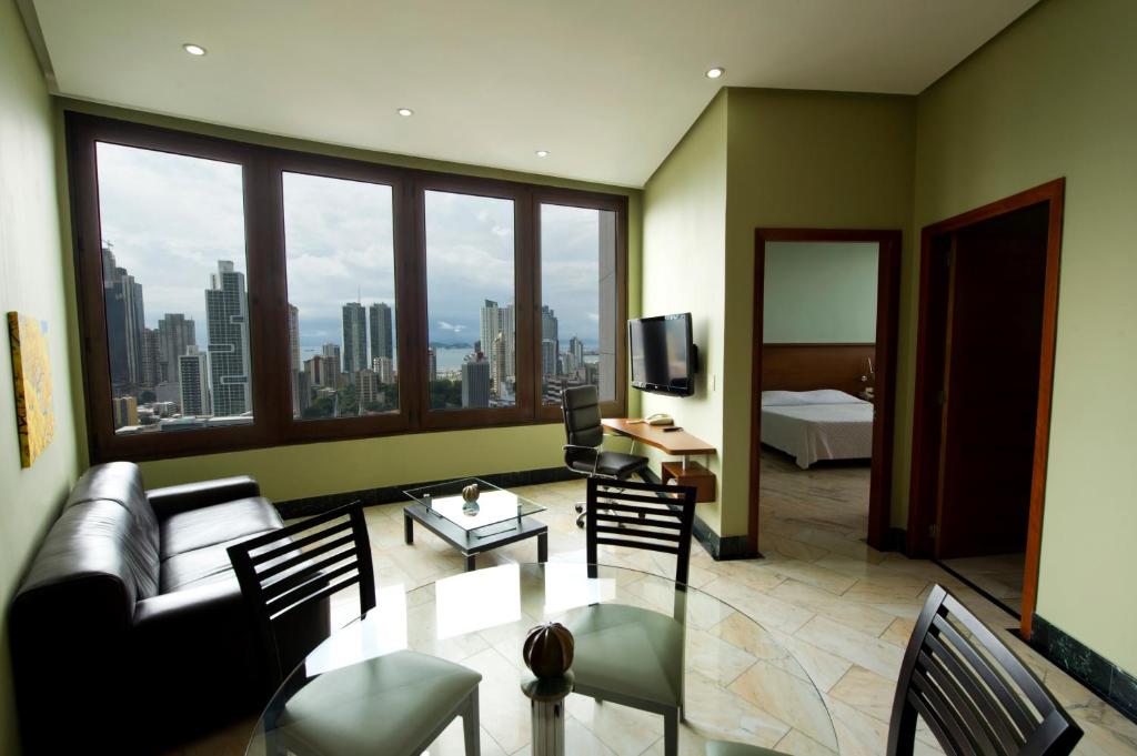a living room with a couch and a table at Torres de Alba Hotel & Suites in Panama City