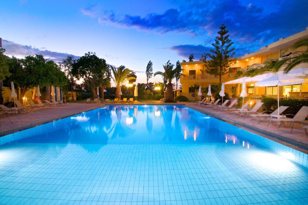 a swimming pool in a resort at night at Solimar Ruby in Malia