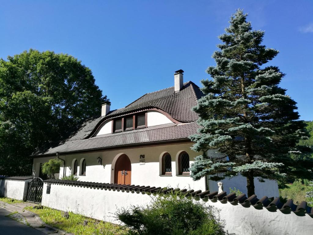 ein Haus mit einem Baum davor in der Unterkunft Longmen Mountain Villa in Egloffstein