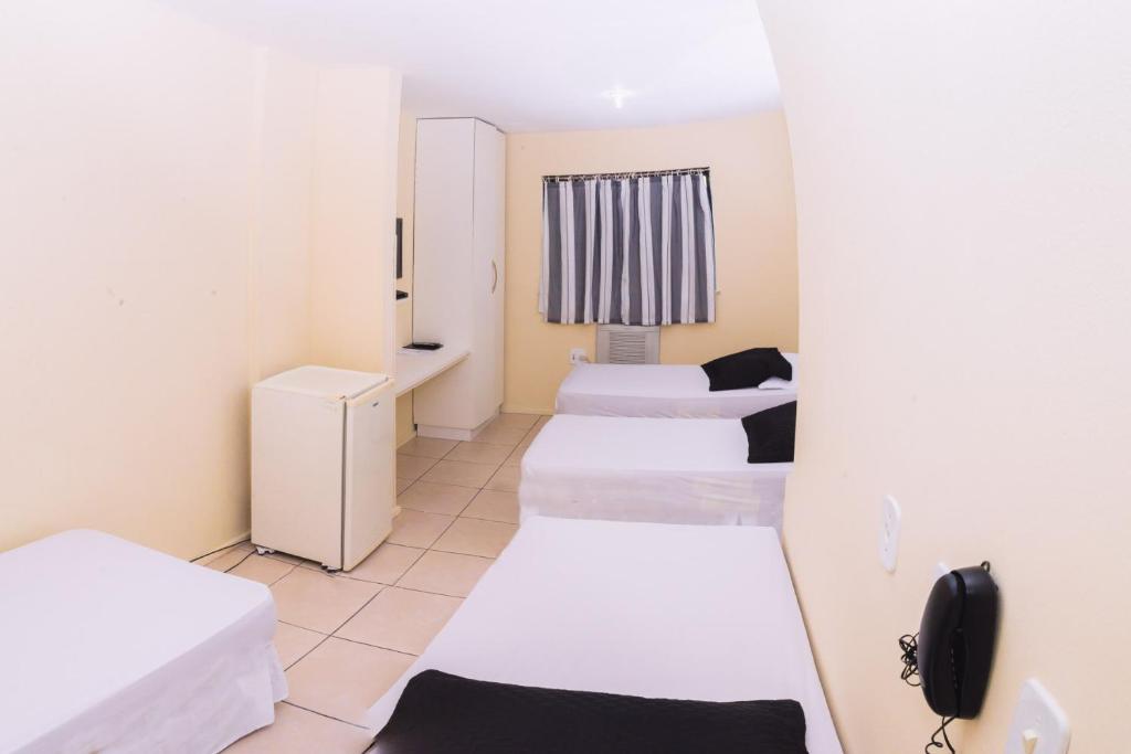 Кровать или кровати в номере Stratus Centro Hotel