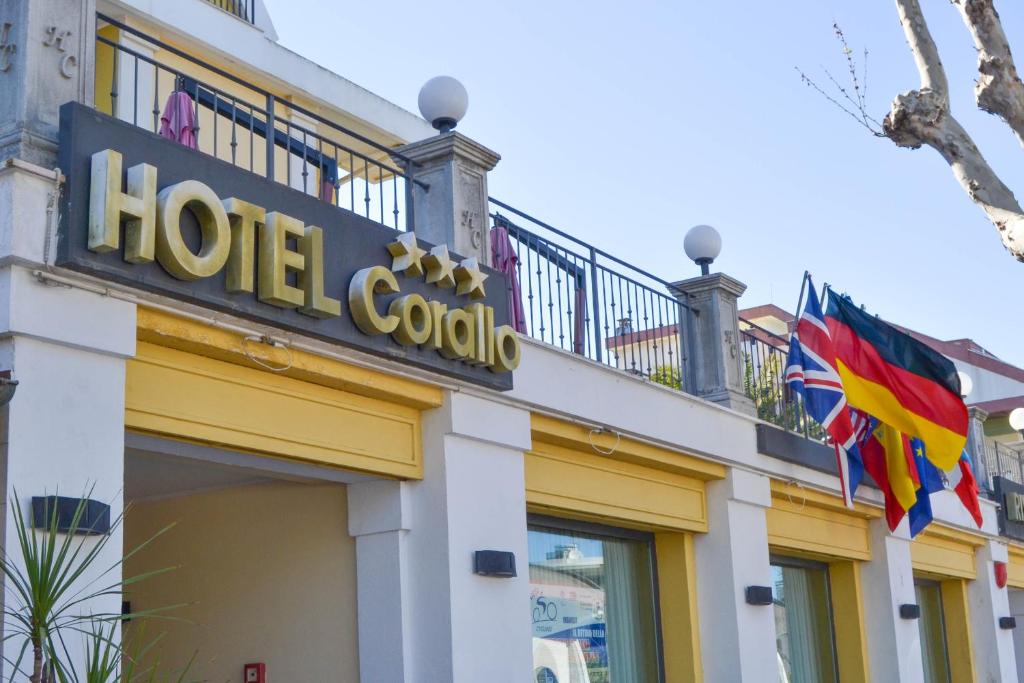 a hotel colombia sign and flags on a building at Hotel Corallo in Francavilla al Mare