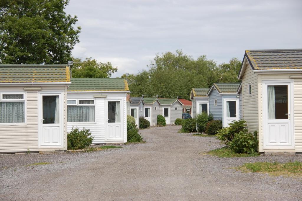 a row of white homes parked in a row at Warrens Village Motel and Self Catering in Clevedon
