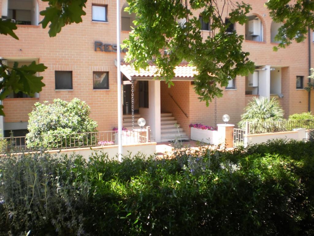 a brick building with stairs and plants in front of it at RTA Le Corti in Grosseto