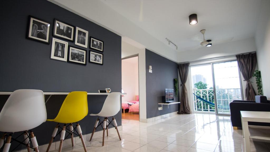 a living room with two yellow chairs and a table at Stay Next to the Event ~ Bukit Jalil Stadium in Kuala Lumpur