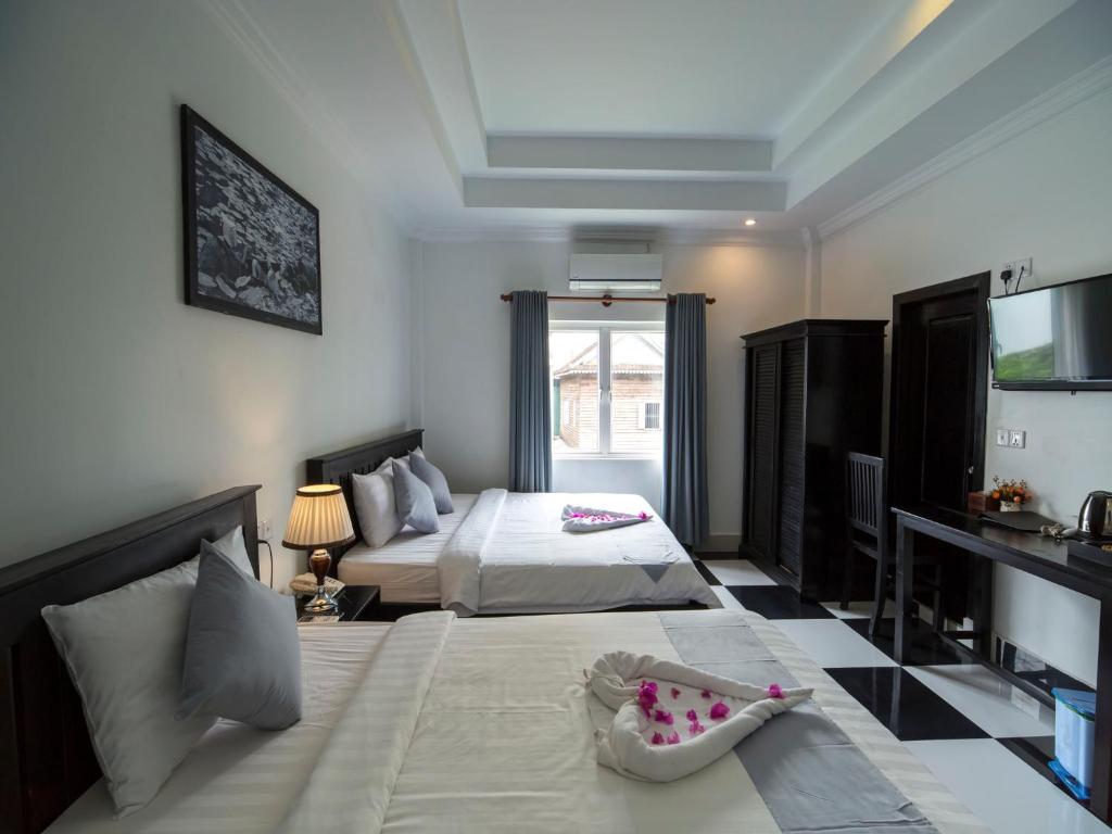 Postel nebo postele na pokoji v ubytování Rithy Rine Angkor Residence