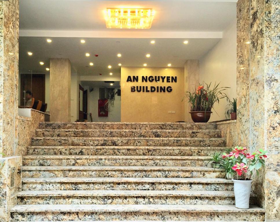 a set of stairs in a building with a sign at An Nguyen Building in Hanoi