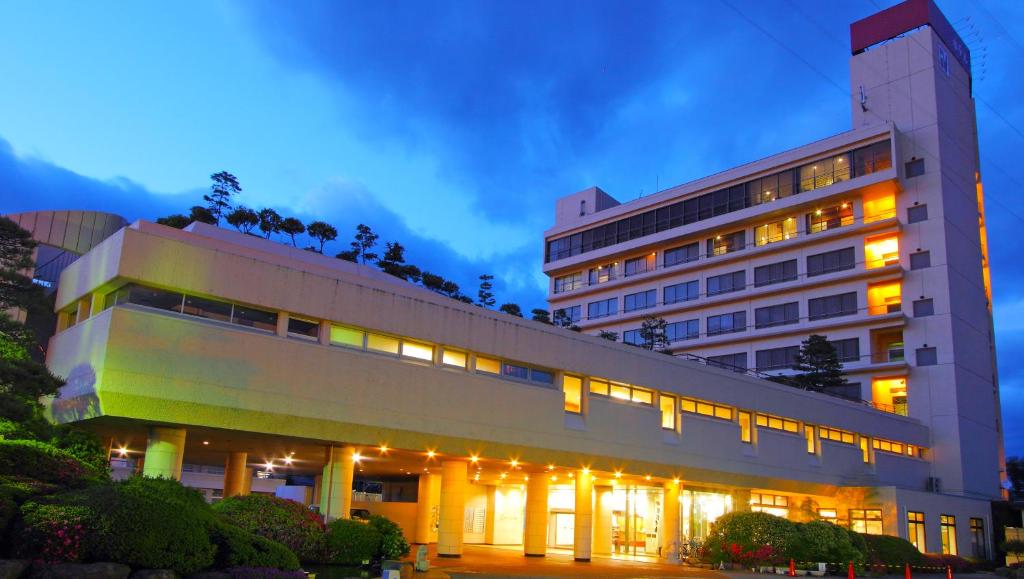 a large building with lights on top of it at Hotel Hana Isawa in Fuefuki