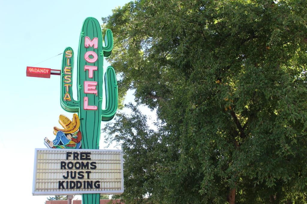 a sign for a cactus motel with a sign at The Siesta Motel in Durango