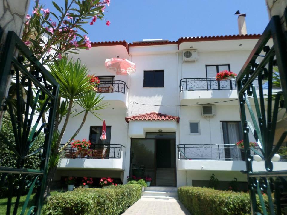 un edificio de apartamentos blanco con flores en los balcones en Mary's Apartments, en Chrani