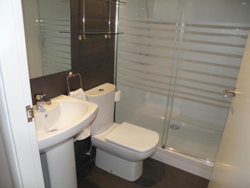 a bathroom with a toilet and a sink and a shower at Center Gran Via in Barcelona
