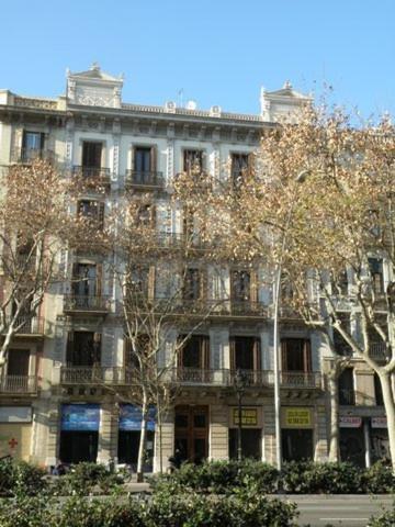 a large white building with a lot of windows at Center Gran Via in Barcelona
