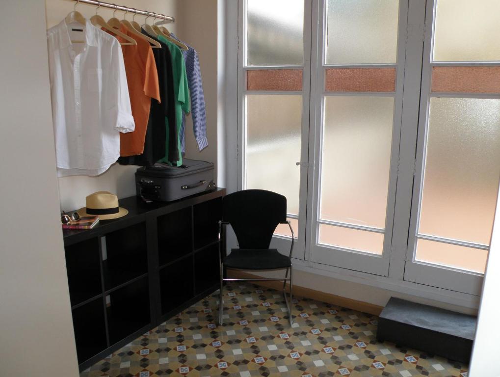 a room with a desk and a chair and a window at Center Gran Via in Barcelona